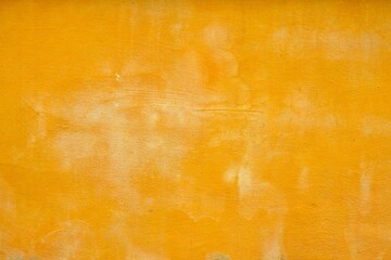 A yellow wall with a textured surface