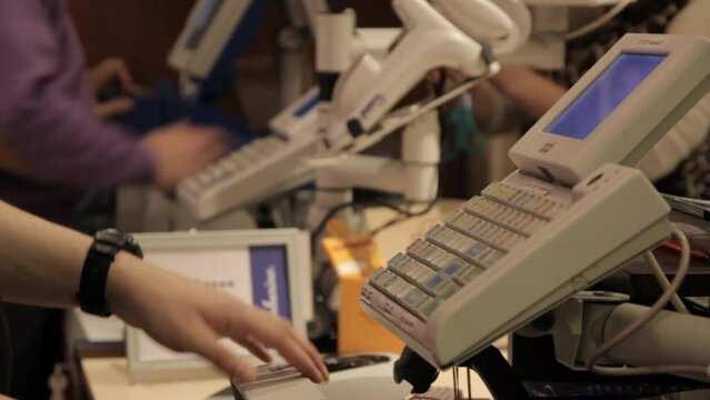 handheld shot of a cashier at a register