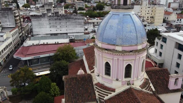 Fly pass crucifix to blue mosaic tile dome on Salta Cathedral, ARG