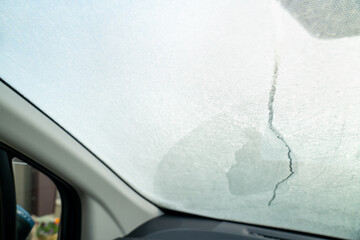 寒さで凍結した車のフロントガラスの写真