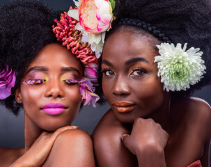 Creative, beauty and black woman with flowers in makeup and art in dark background, studio and...