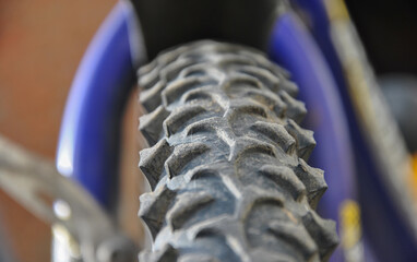 close up of a bicycle tire.  blurred background