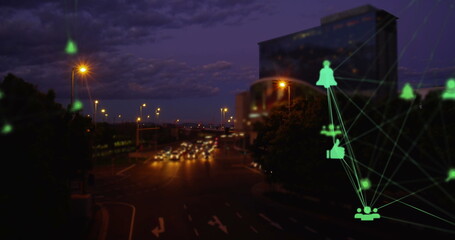 Image of a green web of connections with social icons over fast motion cars riding on a street
