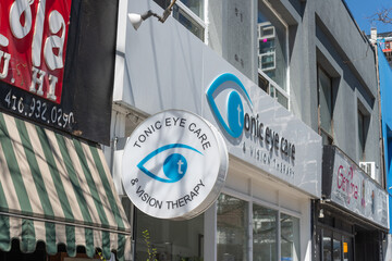 Fototapeta premium exterior projecting sign and building of Tonic Eye Care & Vision Therapy, an optometrist office, located at 2074 Yonge Street in Toronto, Canada