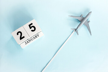 January calendar with number  25. Top view of a calendar with a flying passenger plane. Planner for the year by date of the day. Copy space.