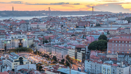 Lisbon after sunset aerial panorama view of city centre with red roofs at Autumn day to night...