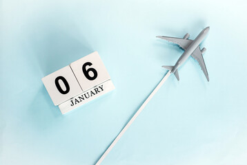 January calendar with number  6. Top view of a calendar with a flying passenger plane. Planner for...