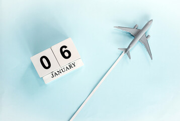 January calendar with number  6. Top view of a calendar with a flying passenger plane. Planner for the year by date of the day. Copy space.