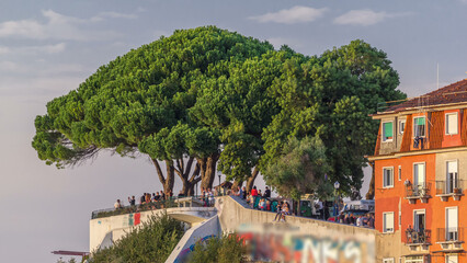 Tourists at Belvedere of Our Lady of the Hill viewpoint, looking at the cityscape of Lisbon at...