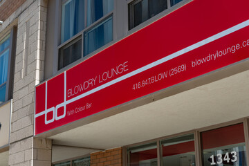 Fototapeta premium exterior sign of Blowdry Lounge, a hair salon, located at 1343 Yonge Street in Toronto, Canada