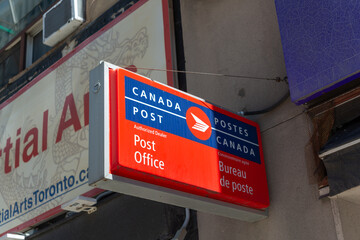 Fototapeta premium projecting light box sign of Canada Post at a Post Office in Toronto, Canada
