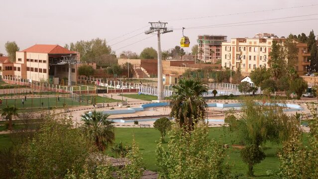 Cableway over the Grand Bassin square in Tlemcen, Algeria. Orange haze in the sky due to close desert sand storms.