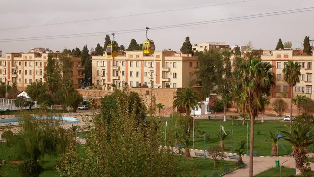 Cableway over the Grand Bassin square in Tlemcen, Algeria. Orange haze due to winds from the Sahara desert.