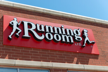 Obraz premium exterior building and sign of Running Room, a fitness shoe and apparel shop, located at 1087 Yonge Street in downtown Toronto, Canada