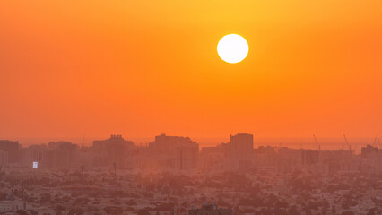 Sunset in Ajman aerial view from rooftop timelapse. United Arab Emirates.