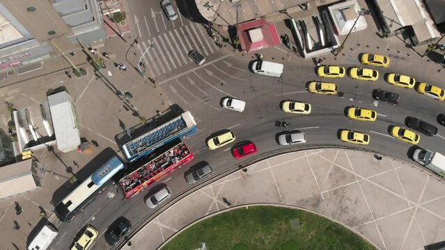 Aerial view of a crossroad with dense traffic in the city center of Athens (drone footage)