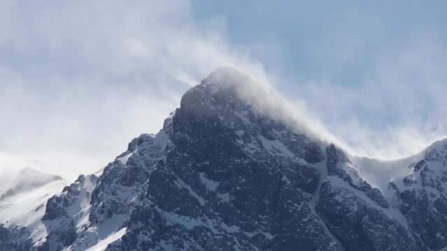 Timelapse in the Rocky Mountains in winter as spindrift blows from summit in high winds - Telluride, Colorado
