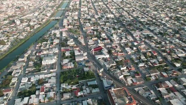 Drone image ascending and unveiling the city of Reynosa, Tamaulipas, Mexico, and its beautiful Santa Catarina River.
