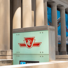 Naklejka premium logo sign marking entrance to TTC station at Union with landmark heritage building behind located at 55 Front Street West in downtown Toronto, Canada