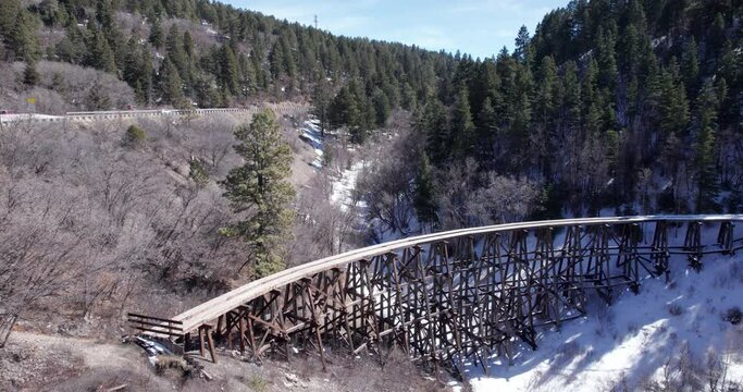 Aerial push in on a historic narrow gauge railway truss in New Mexico, near Cloudcroft