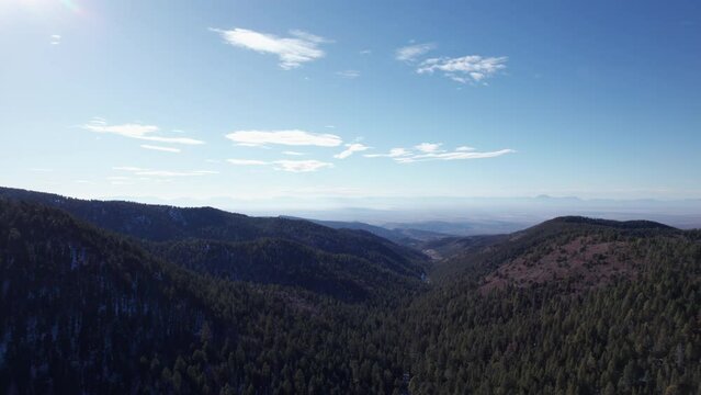 High angle aerial view pull out of the mountains and valleys near Cloudcroft, New Mexico