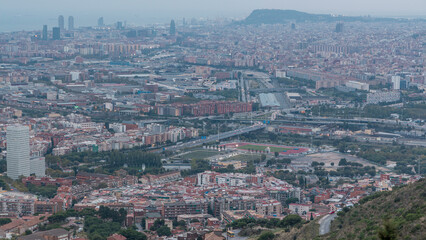 Barcelona and Badalona skyline with roofs of houses and sea on the horizon day to night timelapse