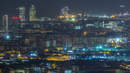 Barcelona and Badalona skyline with roofs of houses and sea on the horizon day to night timelapse