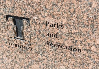 Obraz premium granite stone marker and sign at Simcoe Park located on Front Street West (255 Wellington Street West) in Toronto, Canada