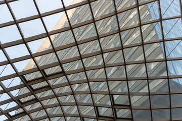 Obraz premium glancing up at the semi-open metal lattice ceiling with transparent panels, spanning the walkway of the shopping complex located at The Well (486 Front Street West in Toronto, Canada)