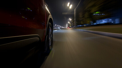 Drivelapse urban look from fast driving car at a night avenue in a city timelapse hyperlapse