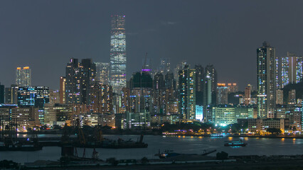 Top view of Hong Kong at night, aerial view from Kowloon bay downtown timelapse