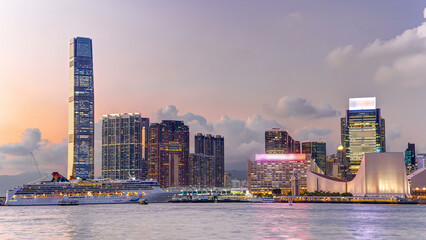 Hong Kong business center day to night timelapse with a cloudy blue sky before sunset
