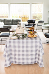 Baby shower cake and dessert table setup in elegant home