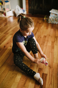 6 year old girl pulling on socks