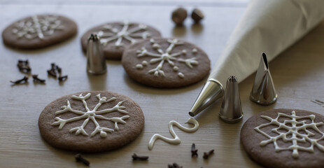 Artistic snowflake icing on holiday gingerbread cookies