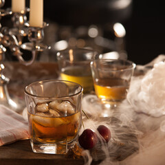 Whiskey on the rocks with an eerie, misty backdrop