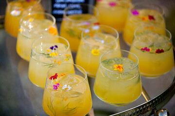 Colorful cocktails garnished with delicate edible flowers.