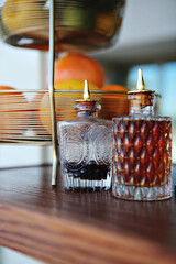 Vintage bitters bottles with intricate designs on a bar setup.