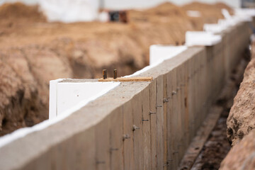 Close-up of a concrete wall with polyfoams at an industrial construction site