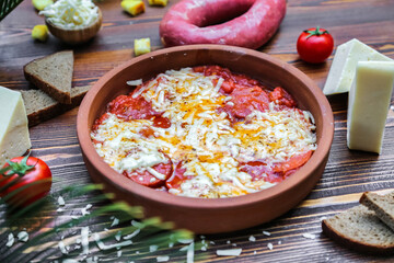A Bowl of Food With Cheese and Tomatoes