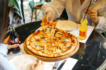 Person Cutting Pizza With Knife and Fork