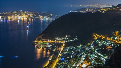 Night timelapse view of the Mediterranean coastline of the town of Eze village on the French Riviera - obrazy, fototapety, plakaty