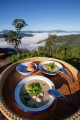 selective focus breakfast on a homestay on a mountain top, background view of misty mountains,...