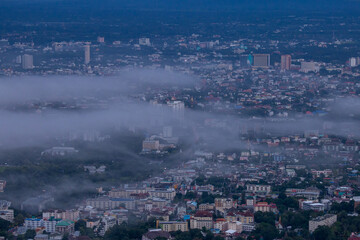 Obraz premium High-angle view of the city with mist passing through. Many buildings in Chiang Mai, Thailand