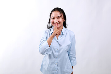 Lifestyle, people emotions and office concept. Smiling cute asian girl asking keep secret, take promise not tell or be quiet about it, show shush sign, hush with finger over mouth, prepare surprise