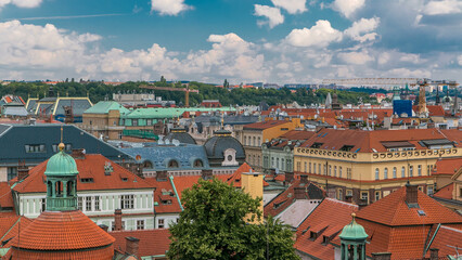 Fototapeta na wymiar Red roofs of the city Prague timelapse shot from the high point on Old Town Bridge Tower