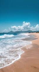 a beach with waves and blue sky
