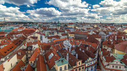 Aerial timelapse view of the traditional red roofs of the city of Prague, Czech Republic with the church of St. Jilji