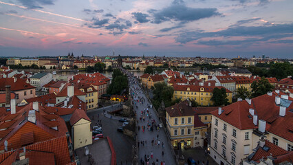 Aerial view of the Old Town architecture and Charles Bridge over Vltava river day to night timelapse in Praha