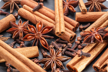 Lots of three spices for mulled wine – star anise, cinnamon and clove, macro.